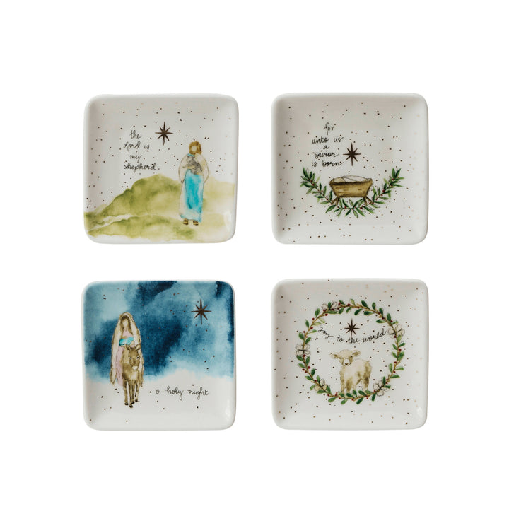 Set of four square ceramic plates with Christmas-themed illustrations and text on a white background.