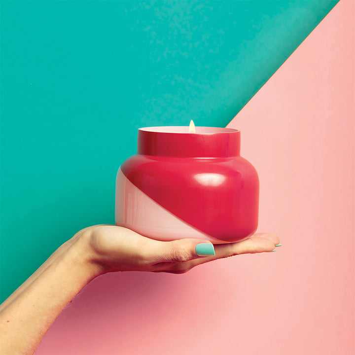 COCONUT SANTAL SIGNATURE DUAL TONE JAR - pink & red jar being held by hand