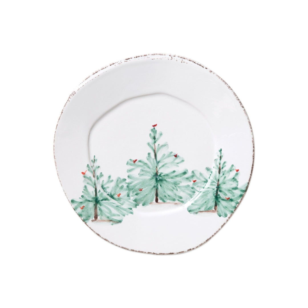 A round white ceramic salad plate with handpainted fir trees and bright cardinals.