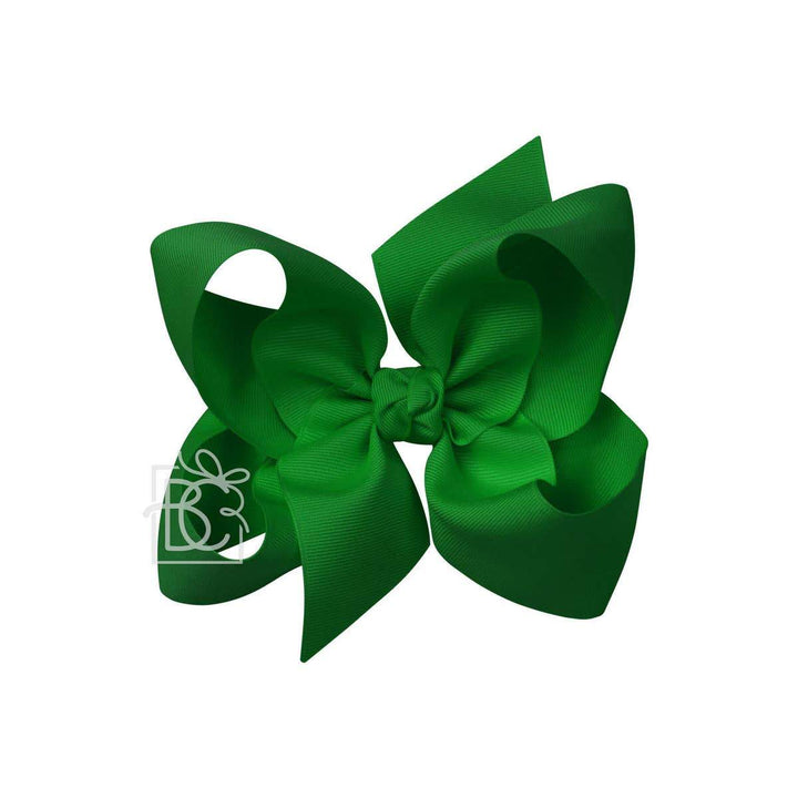 A green hair bow against a white background.