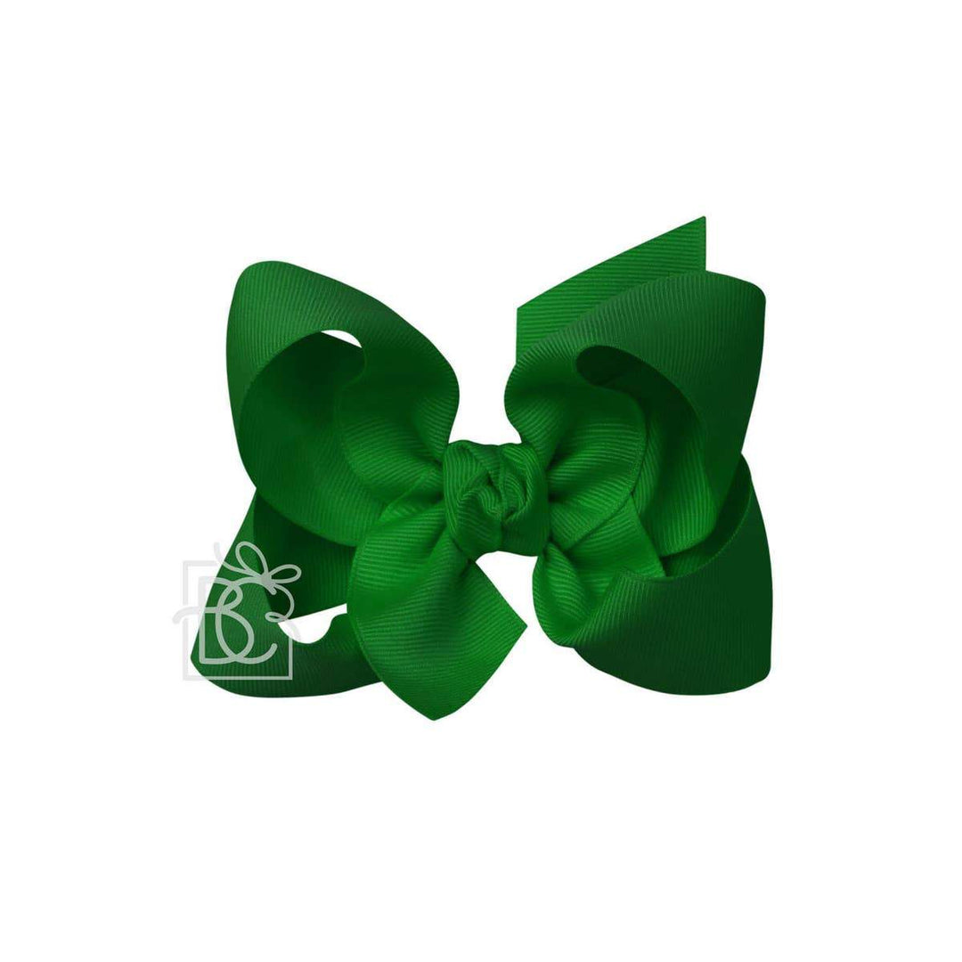 A green hair bow against a white background.