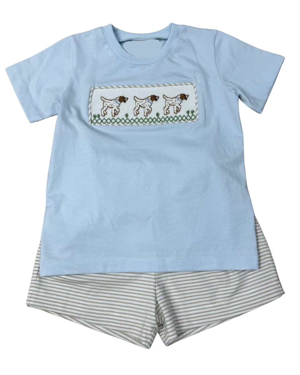 Light blue t-shirt with dog design and gray striped shorts on a white background