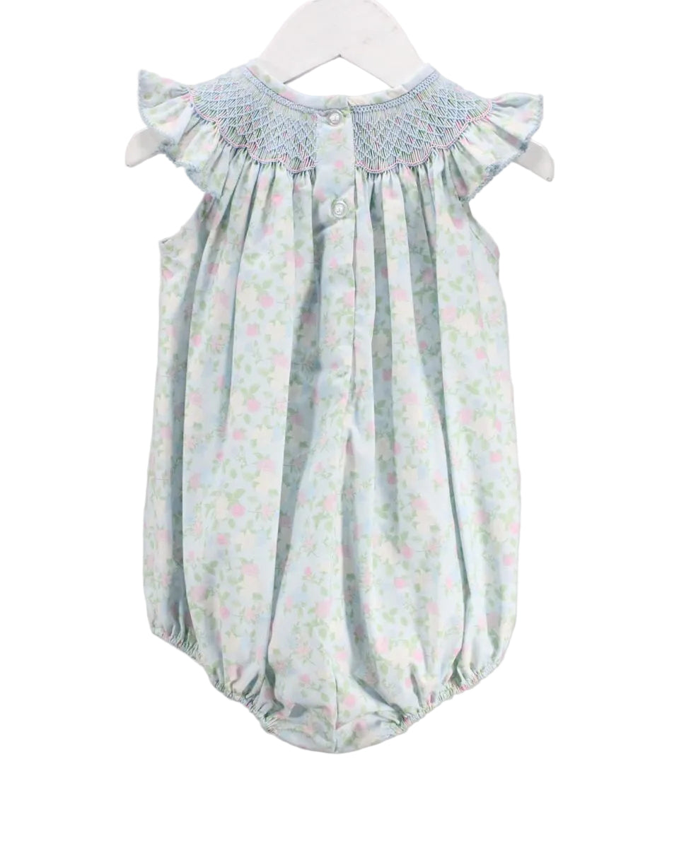 BLUE LITTLE GIRLS BUBBLE WITH FLORAL DETAIL AND SMOCKED NECKLINE ON WHITE BACKGROUND WITH BUTTONS ON BACK