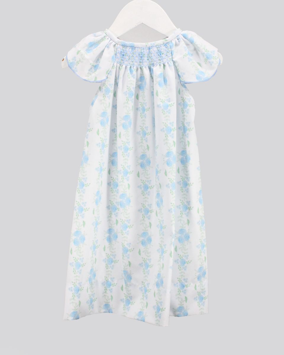 Floral dress on a hanger against a gray background