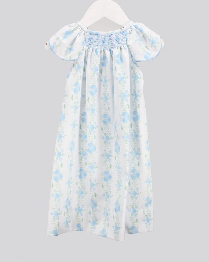 Floral dress on a hanger against a gray background
