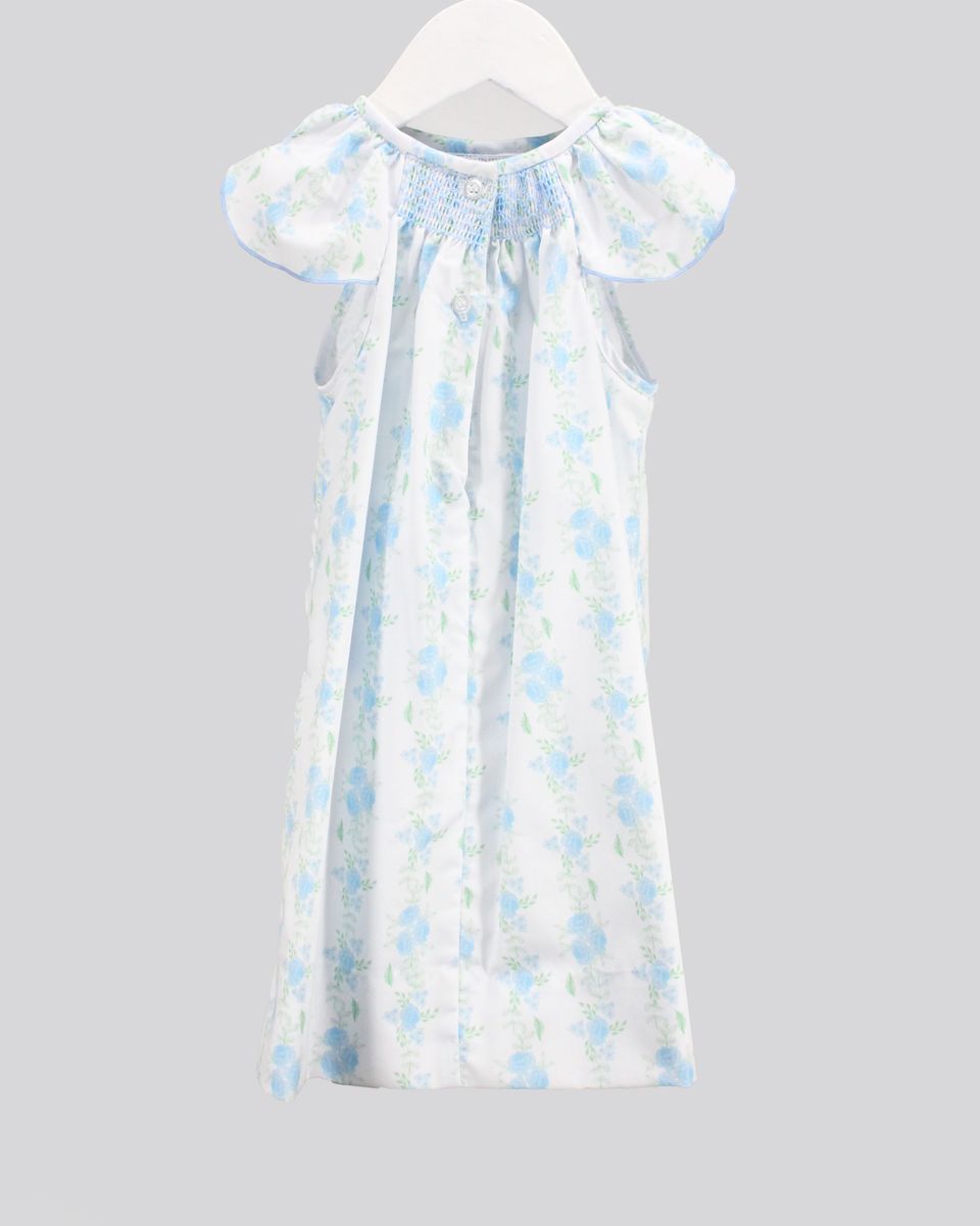 White dress with blue floral pattern on a gray background