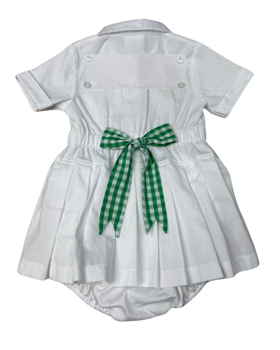 White baby dress with a green checkered bow on a white background