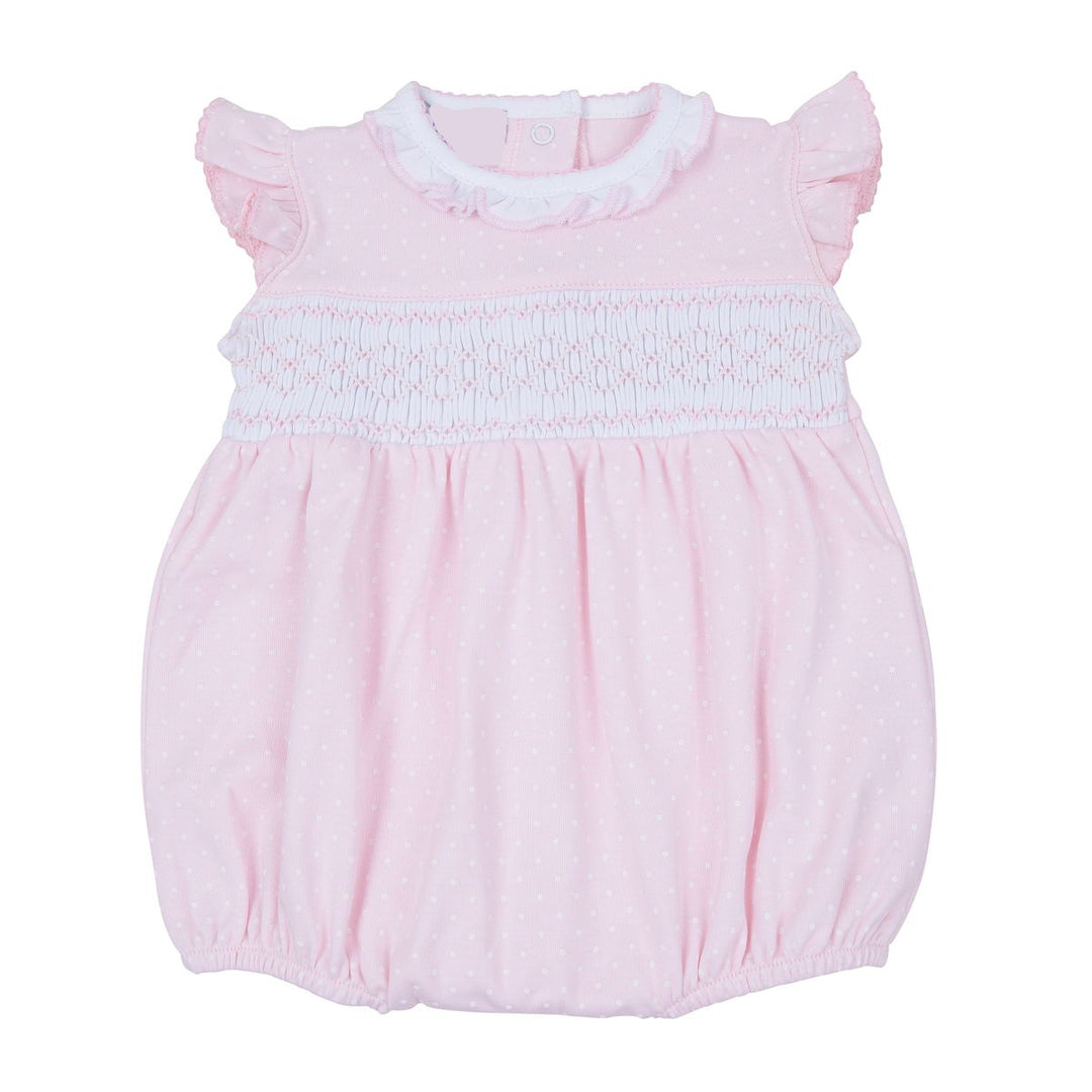 Pink baby romper with smocked bodice on a white background