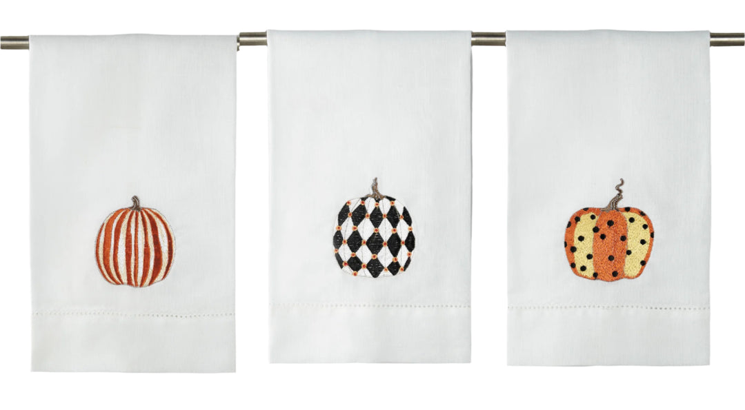 Three decorative towels with pumpkin designs on a white background