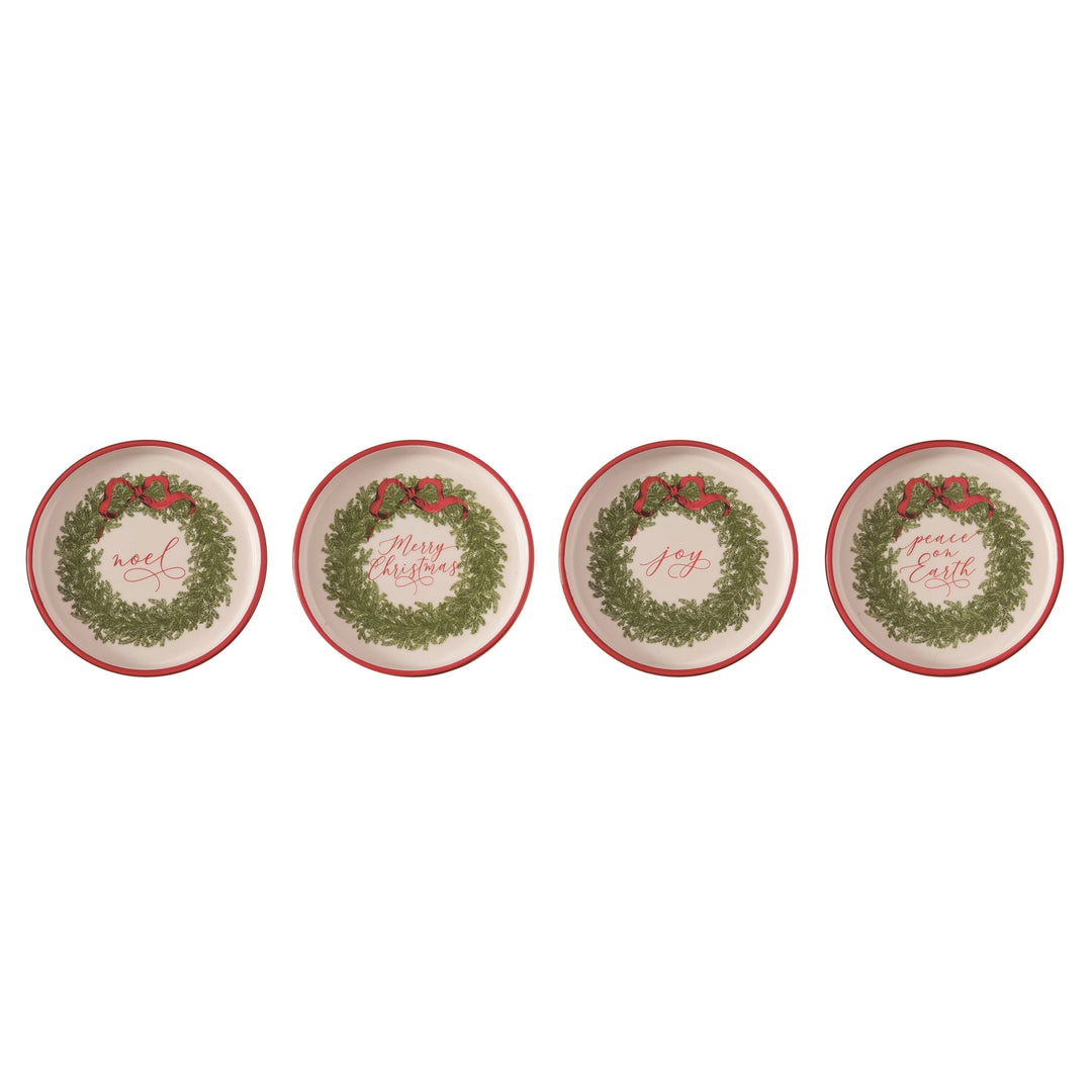 four decorative plates with Christmas wreath designs on a white background