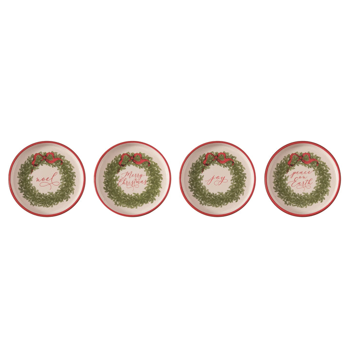 four decorative plates with Christmas wreath designs on a white background