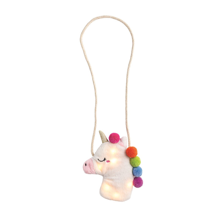 Unicorn-shaped plush purse with colorful pom-poms on a white background