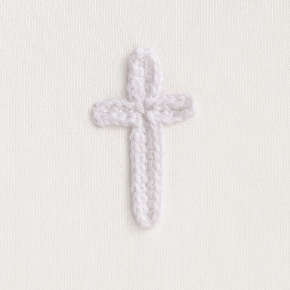 Cotton interlock bib features crochet cross icon and picot stitch detail.