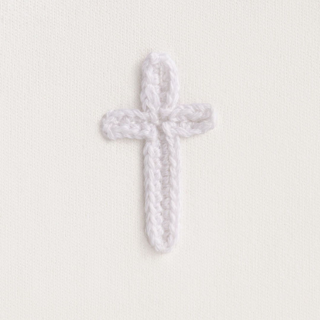 Cotton interlock bib features crochet cross icon and picot stitch detail.