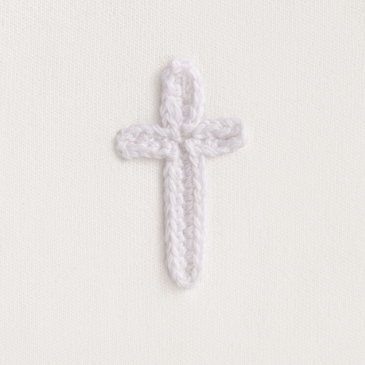 Cotton interlock bib features crochet cross icon and picot stitch detail.