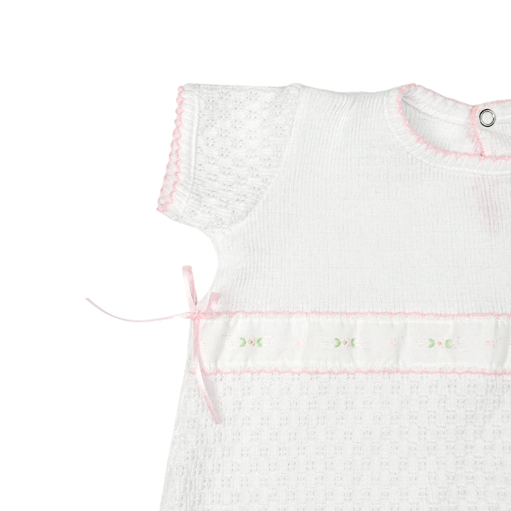 CLOSE UP VIEW OF SLEEVE ON WHITE PATY KNIT ROMPER WITH SPRING FLORALS SHORT SLEEVE