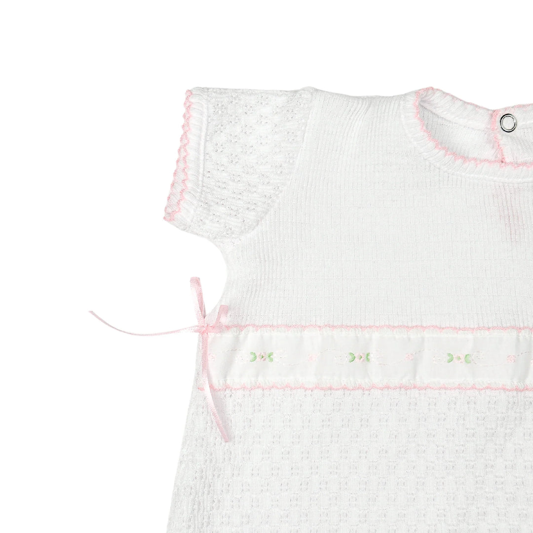 CLOSE UP VIEW OF SLEEVE ON WHITE PATY KNIT ROMPER WITH SPRING FLORALS SHORT SLEEVE