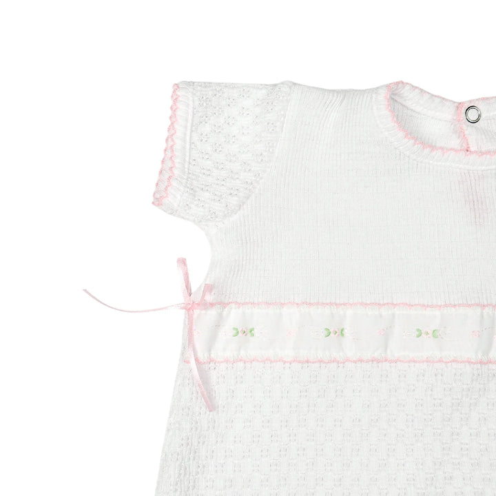 CLOSE UP VIEW OF SLEEVE ON WHITE PATY KNIT ROMPER WITH SPRING FLORALS SHORT SLEEVE