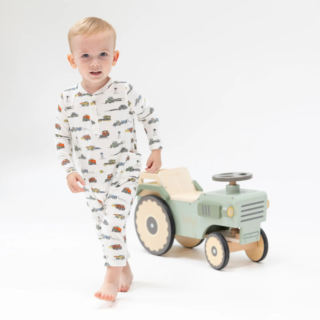Angel Dear Farm Machines Uni Romper worn by a baby in a lifestyle view highlighting the farm machines uni design
