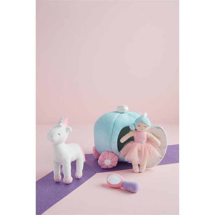 Unicorn plush toy and fairy dollhouse with fairy doll on a pink and purple background