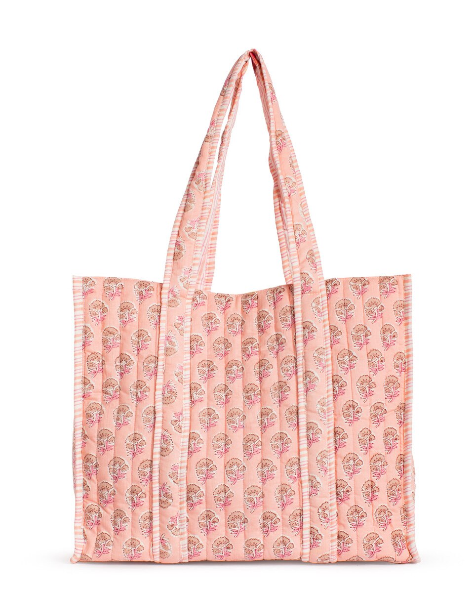 Pink tote bag with floral pattern on a white background
