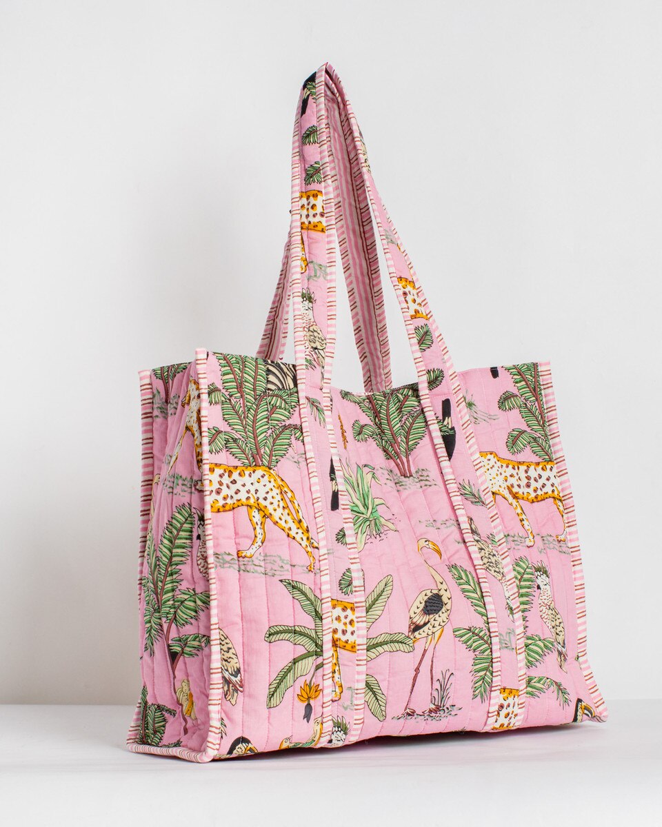 Reusable shopping bag with animal and plant pattern on a pink background