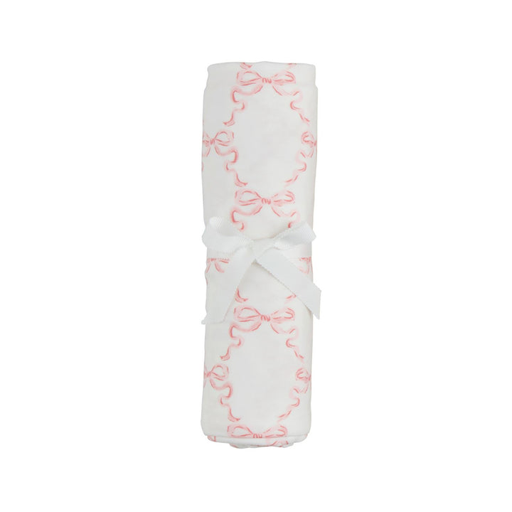 White fabric with pink bow pattern on a white background