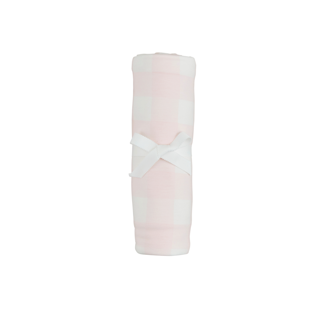 Pink and white folded fabric with a cross pattern on a white background