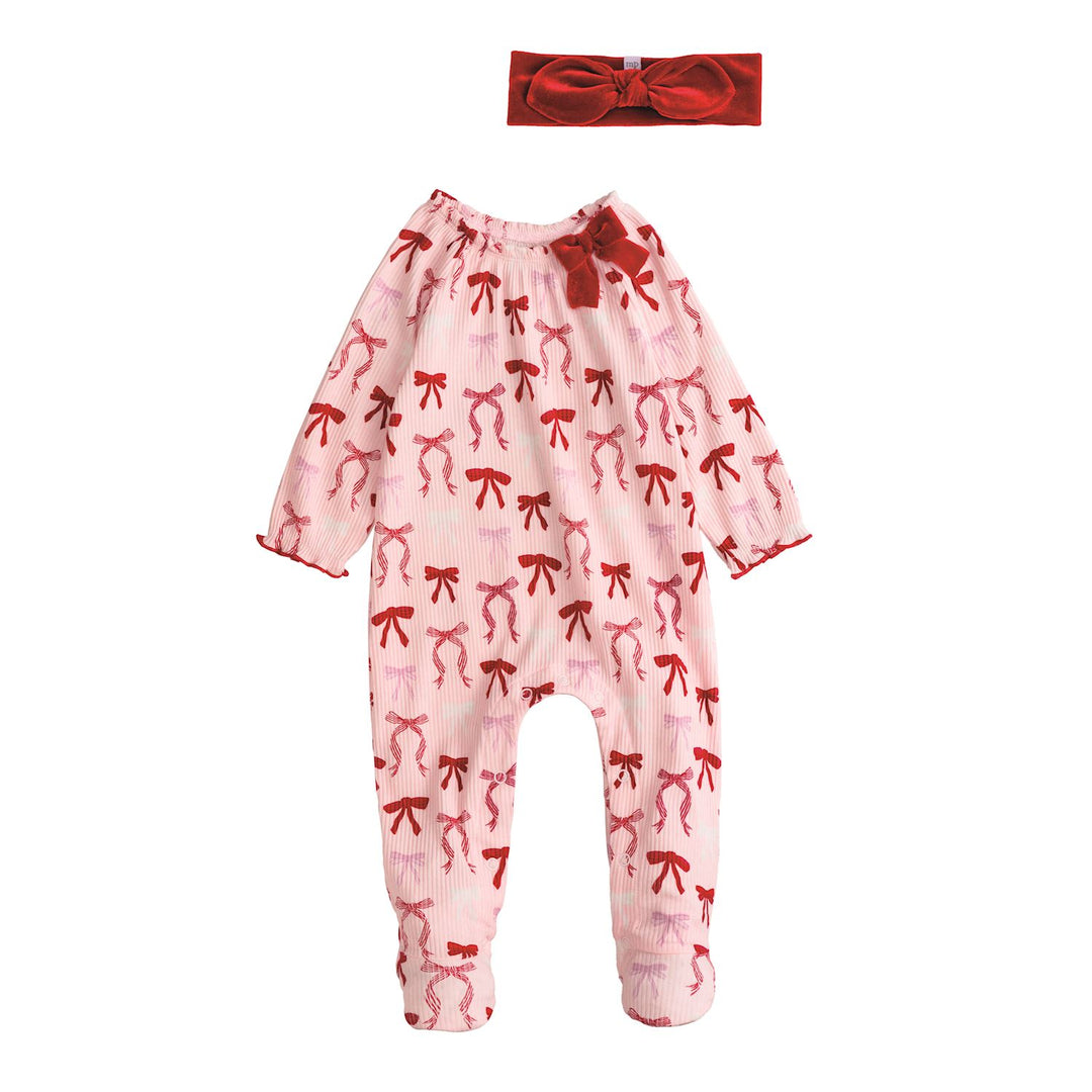 Pink baby onesie with red bow pattern and matching headband on a white background