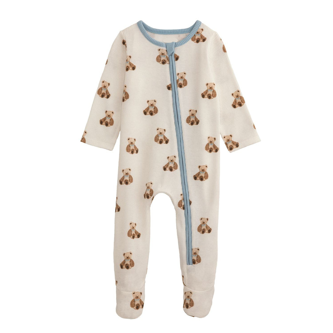 Baby onesie with teddy bear pattern and blue zipper on a white background