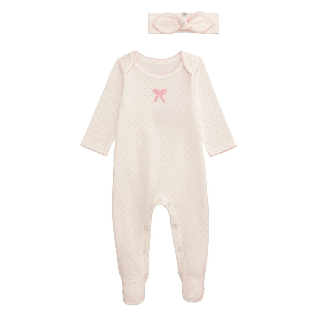 Baby onesie with pink bow and matching headband on a white background