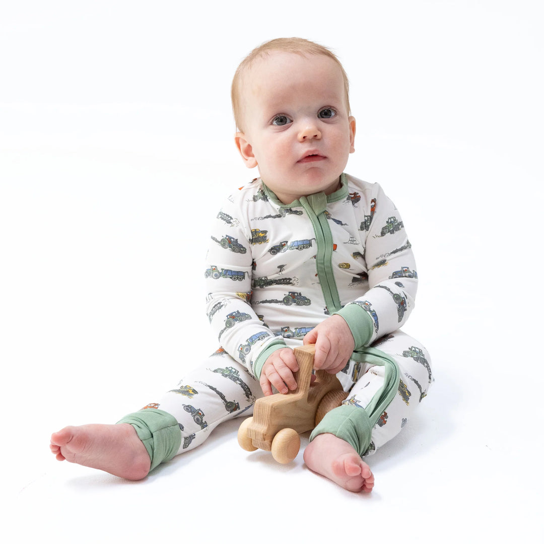 Angel Dear Farm Machines Convertible Romper worn by a baby in a lifestyle view highlighting the farm machines design