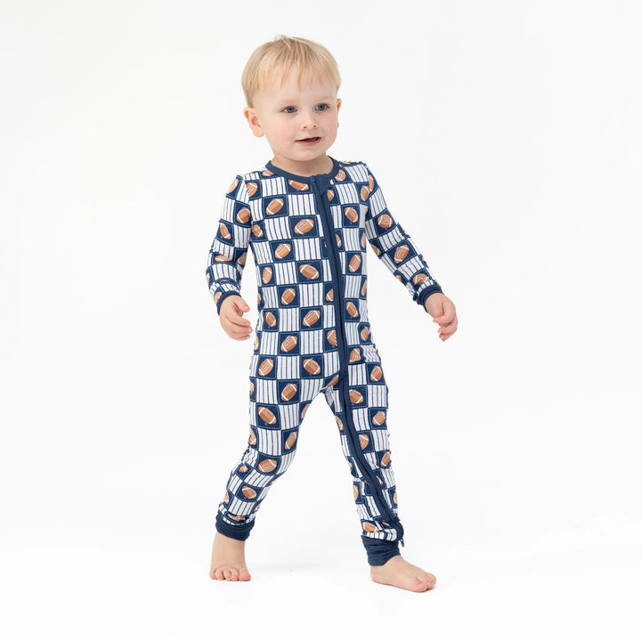 Angel Dear Football Patchwork Convertible Romper worn by a baby in a lifestyle view highlighting the football patchwork design