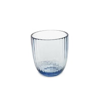 Clear glass tumbler with blue hue on a white background
