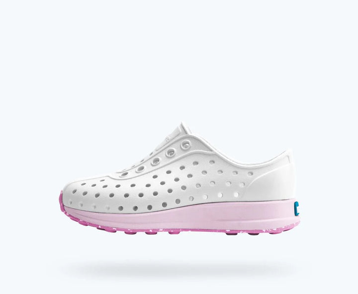 White shoe with pink sole on a white background