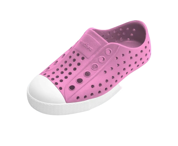 Pink children's shoe with white sole on a white background