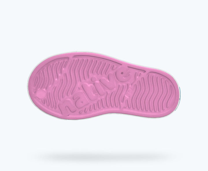 Pink shoe sole with a textured pattern on a white background