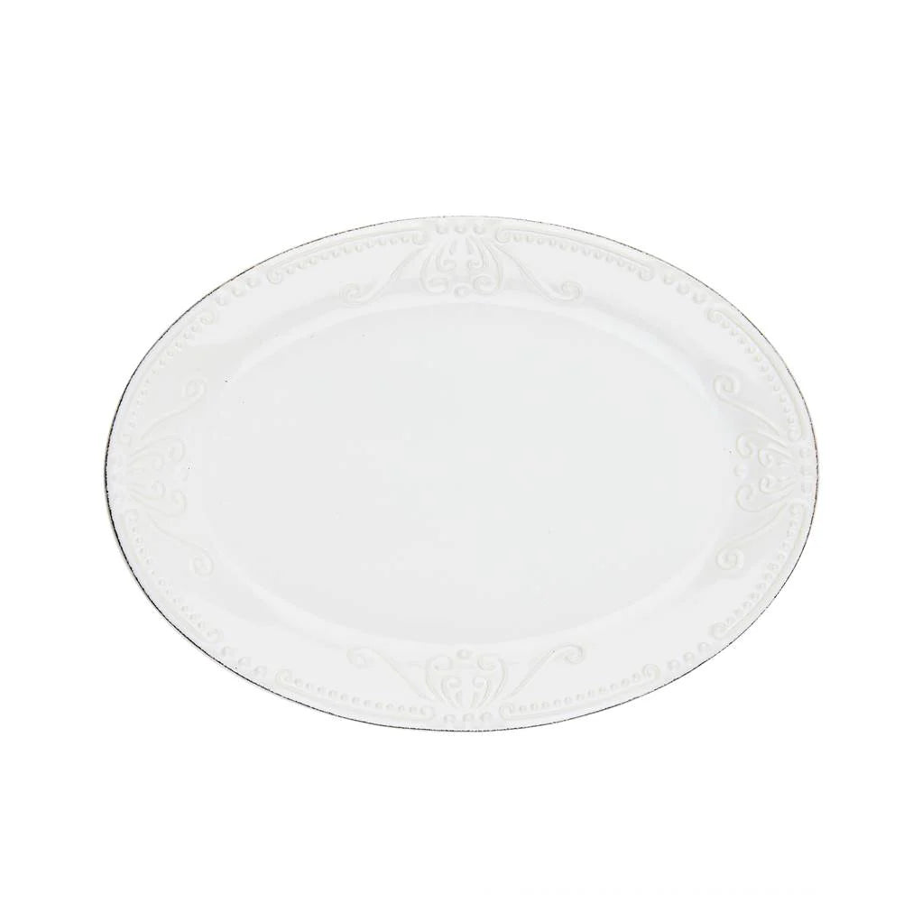 Round white plate with textured surface on a white background