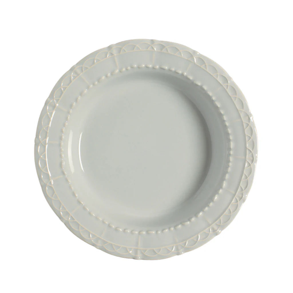 Light blue ceramic plate with decorative rim on a white background