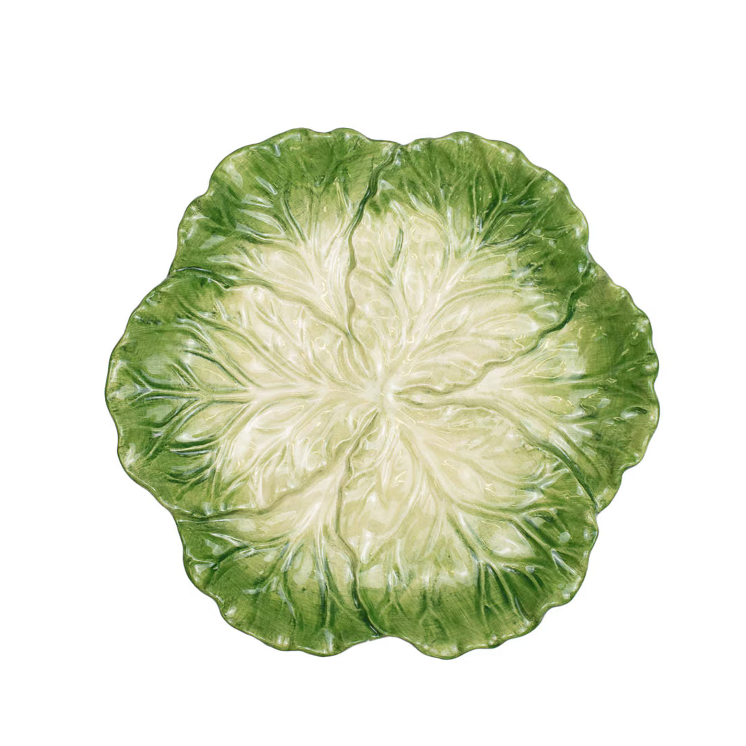 Close-up of a green cabbage leaf plate on a white background