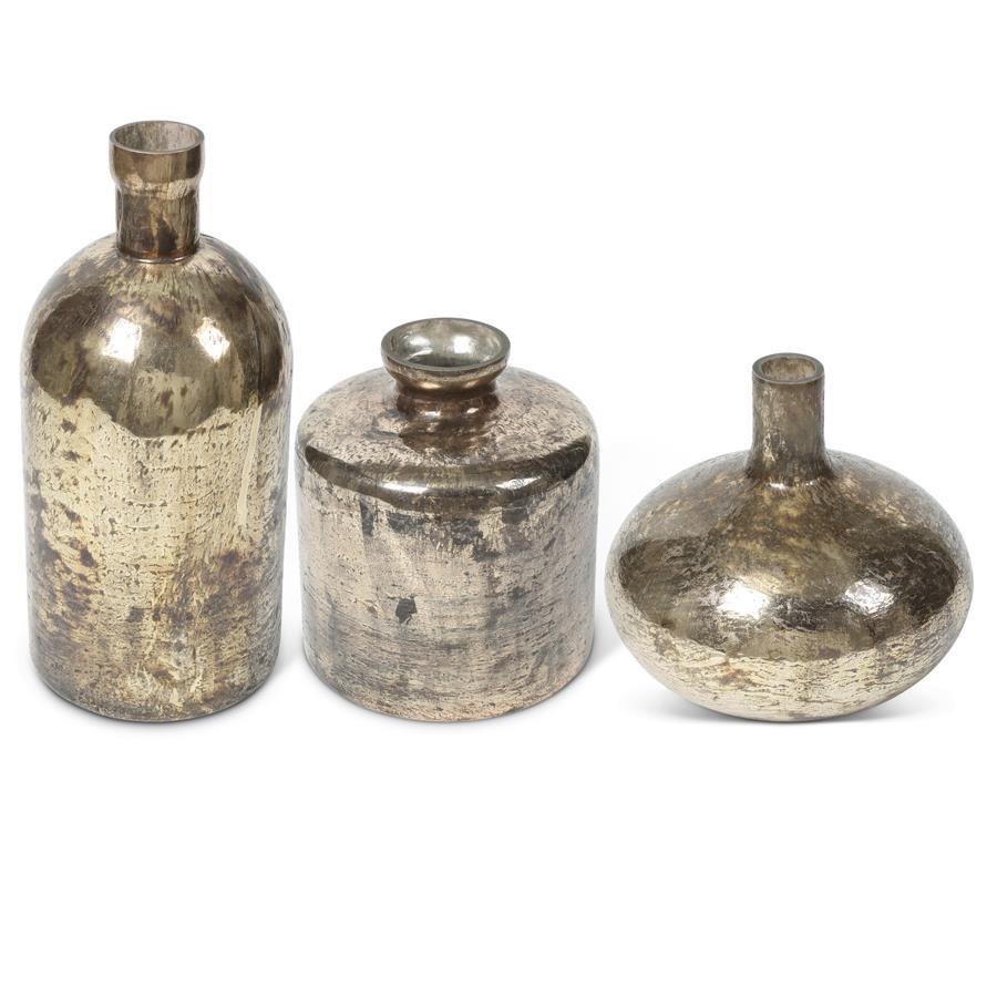 Three metallic decorative bottles on a white background