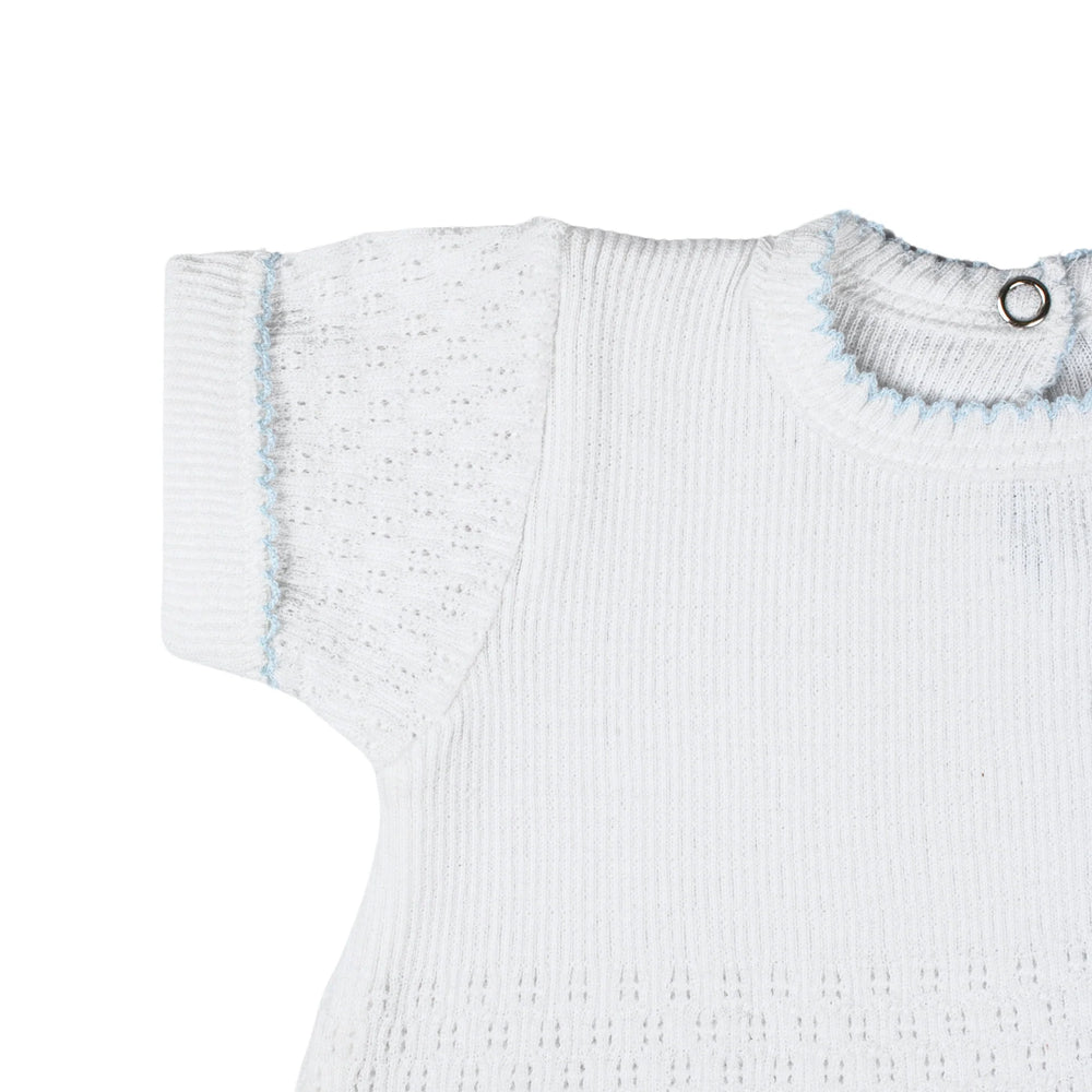 White ribbed baby sweater with blue trim on a white background