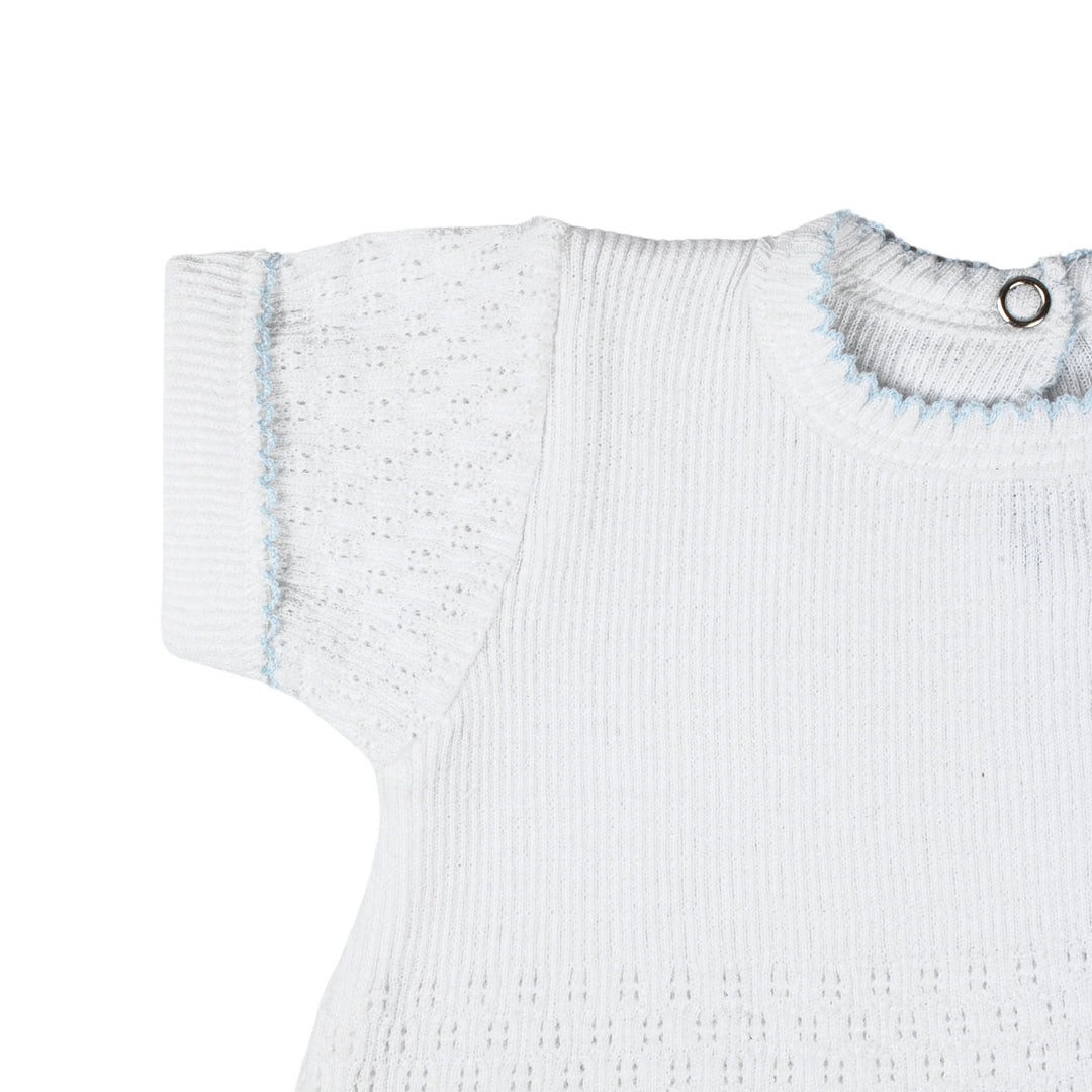 White ribbed baby sweater with blue trim on a white background