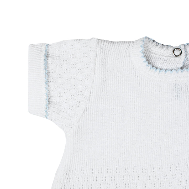 White ribbed baby sweater with blue trim on a white background