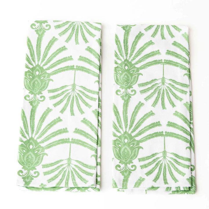 Two green leaf-patterned napkins on a white background