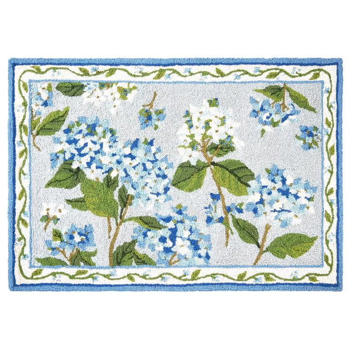 A rectangular blue hydrangea hook rug with floral accents displayed against a white background.