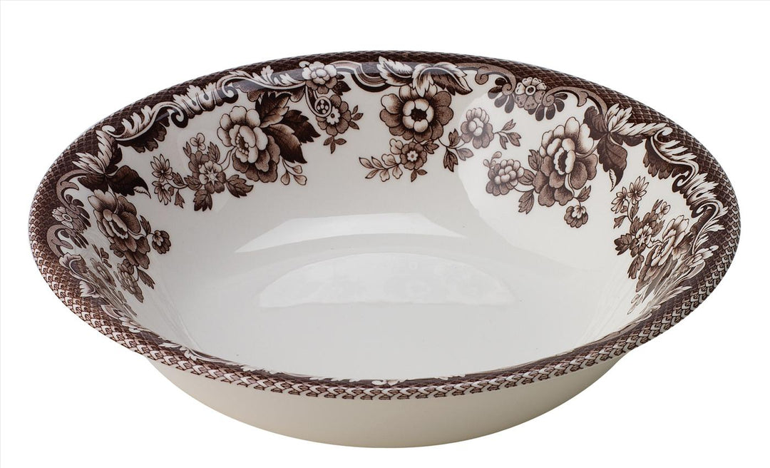 A decorative porcelain cereal bowl with floral patterns primarily in beige, brown, and multicolor.