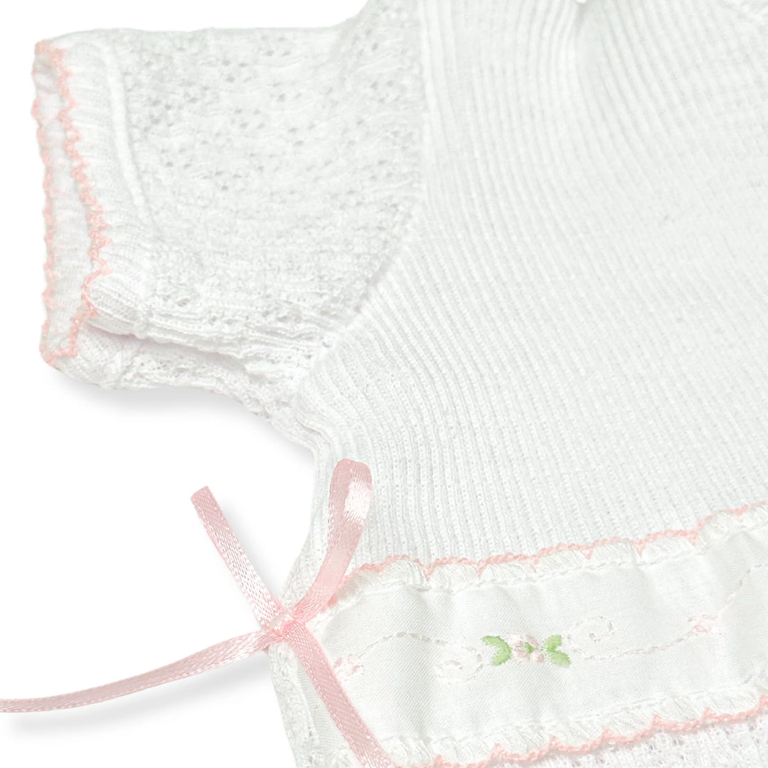 CLOSE UP VIEW OF DETAILS OF WHITE PATY KNIT ROMPER WITH SPRING FLORALS SHORT SLEEVE