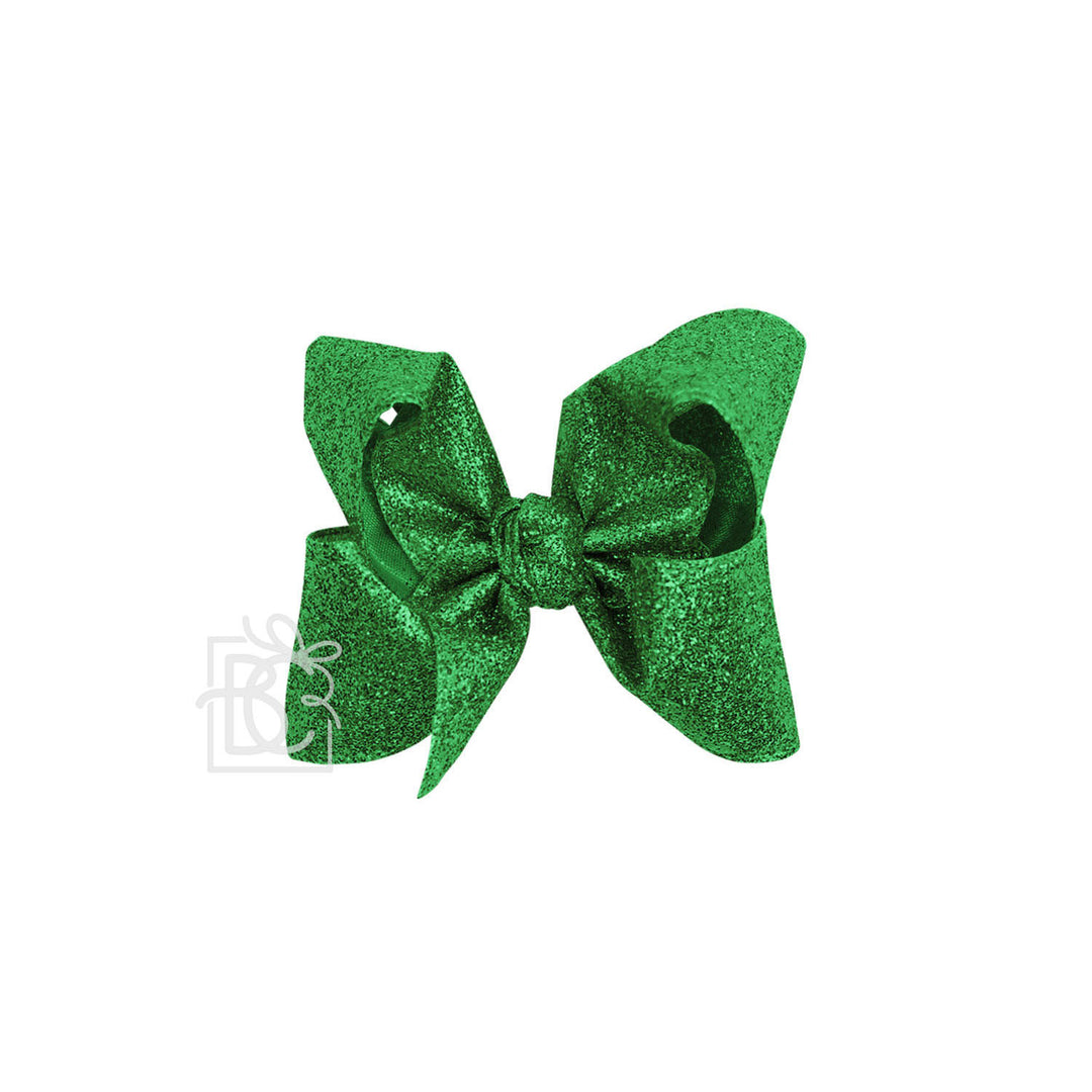 Green glittery bow on a white background