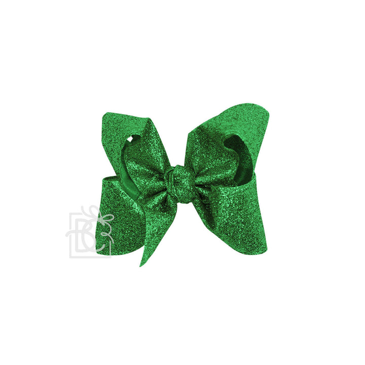 Green glittery bow on a white background
